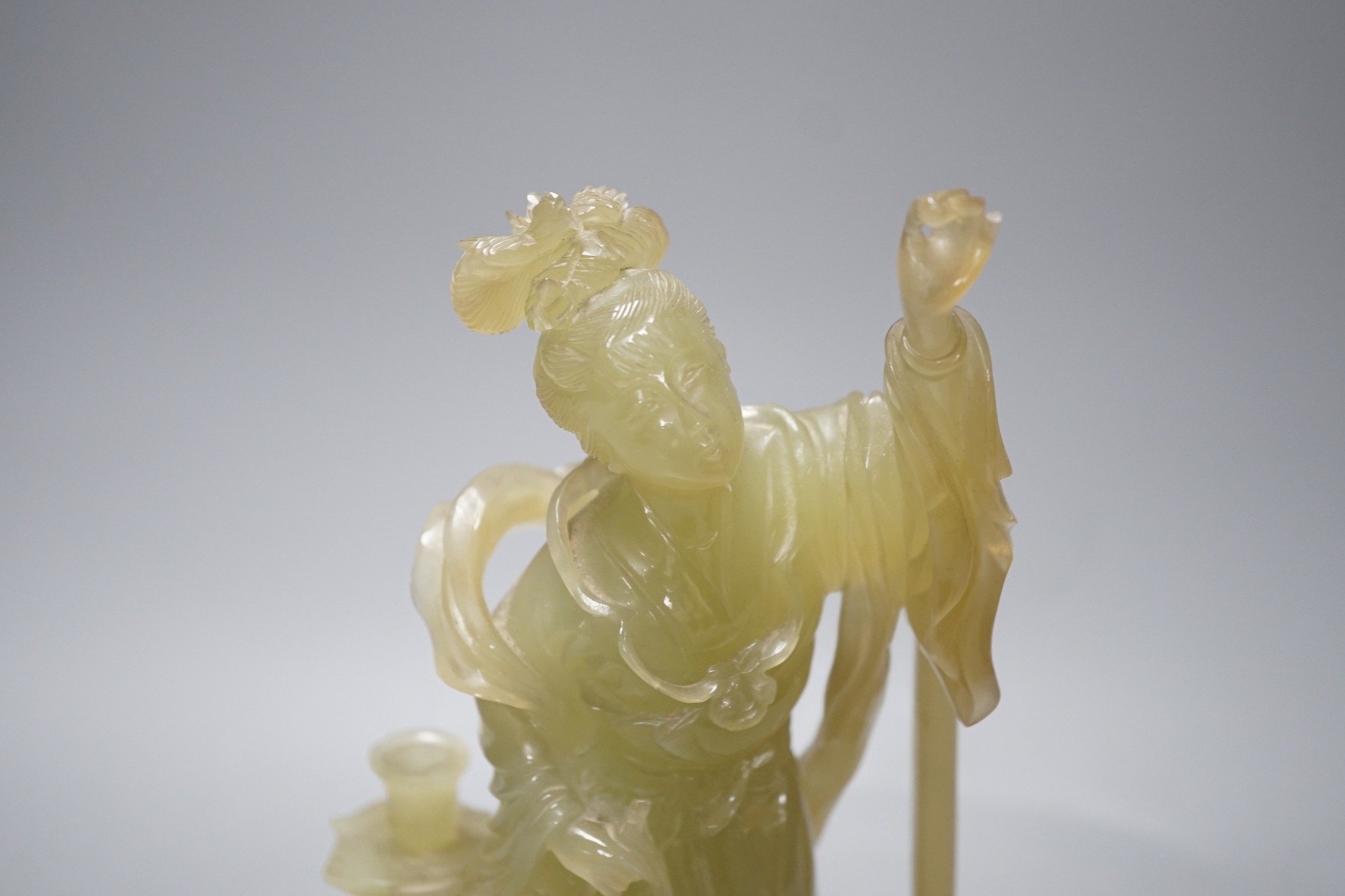 A Chinese carved bowenite jade figure of a lady on a hardwood stand 27cm